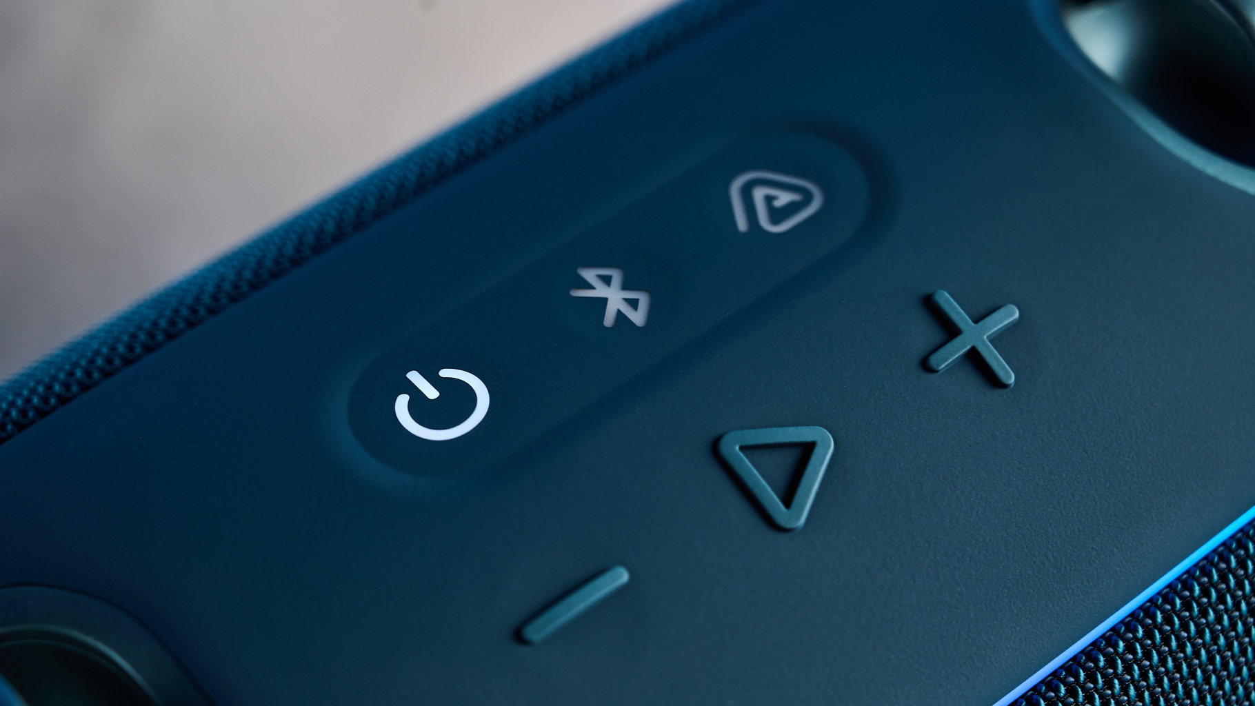 the JBL Xtreme 5 bluetooth speaker in blue shown with the rugged carry strap and buttons