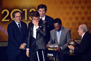 Real Madrid's Portuguese forward Cristiano Ronaldo (C) reacts as he receives the 2013 FIFA Ballon d'Or award for player of the year from Brazilian football legend Pele (2nd-R), France Football president Francois Moriniere (back-C), FIFA president Sepp Blatter (R) and UEFA president Michel Platini (L) during the FIFA Ballon d'Or award ceremony at the Kongresshaus in Zurich on January 13, 2014.during the FIFA Ballon d'Or award ceremony at the Kongresshaus in Zurich on January 13, 2014.