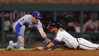 Eddie Rosario #8 of the Atlanta Braves slides safely into second base ahead of the tag of Trea Turner #6 of the Los Angeles Dodgers in the eighth inning of Game Two of the National League Championship Series at Truist Park on Oct. 17, 2021 in Atlanta, Georgia.