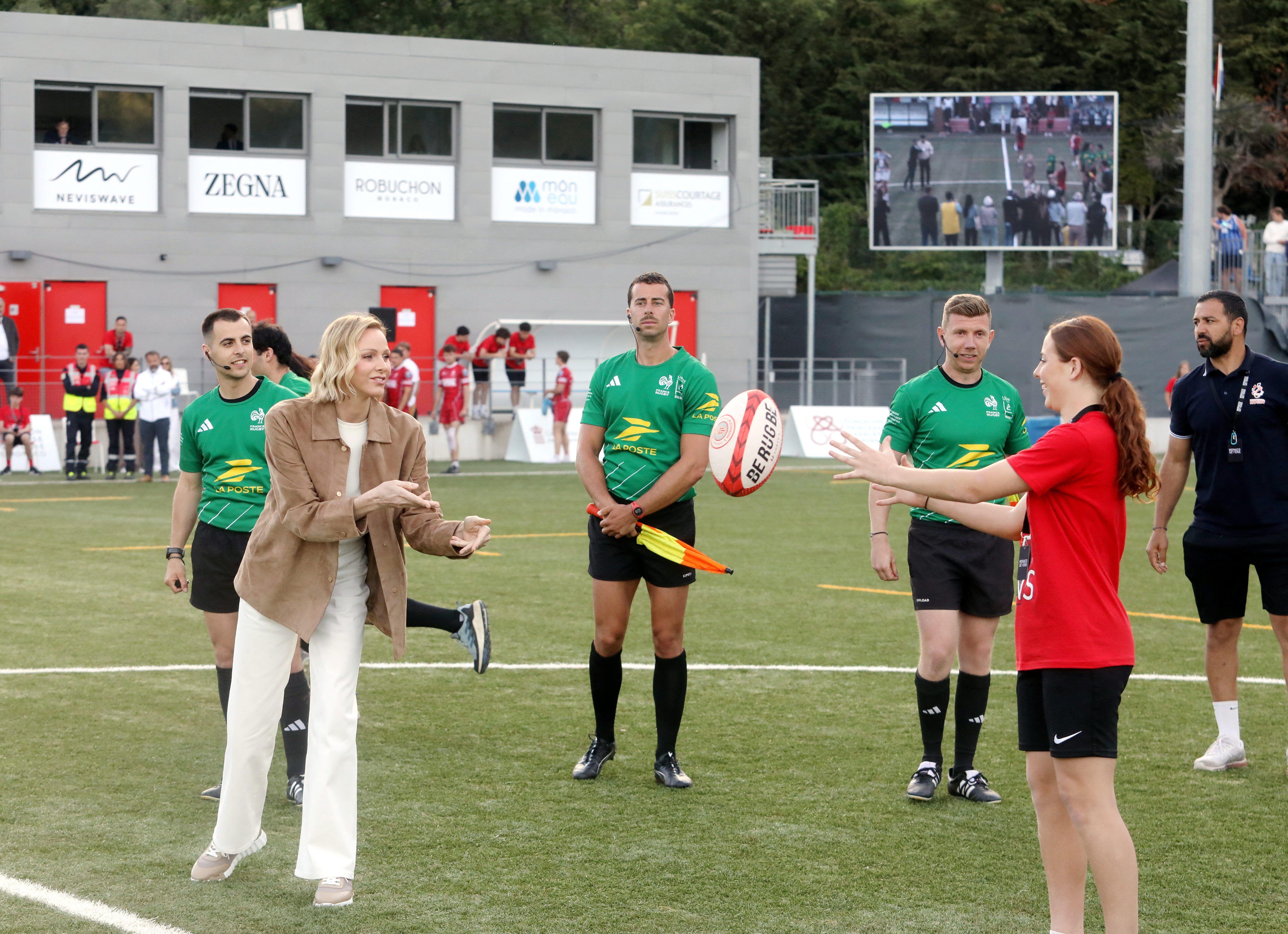 Princess Charlene catching a rugby ball