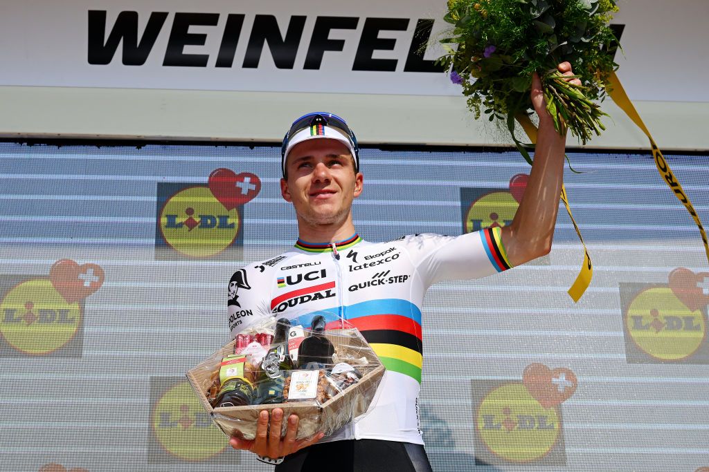 WEINFELDEN SWITZERLAND JUNE 17 Stage winner Remco Evenepoel of Belgium and Team Soudal QuickStep eacts with sadness for the death of Gino Mder of Switzerland and Team Bahrain Victorious during the podium ceremony at the 86th Tour de Suisse 2023 Stage 7 a 1835km stage from Tbach to Weinfelden UCIWT on June 17 2023 in Weinfelden Switzerland Photo by Dario BelingheriGetty Images