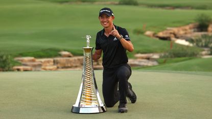 Collin Morikawa poses with the Race to Dubai trophy