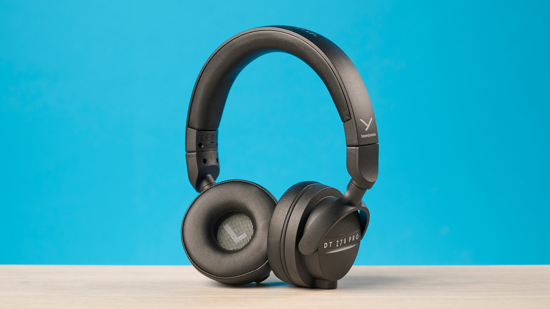 Beyerdynamic DT 275 Pro photographed in front of a blue background