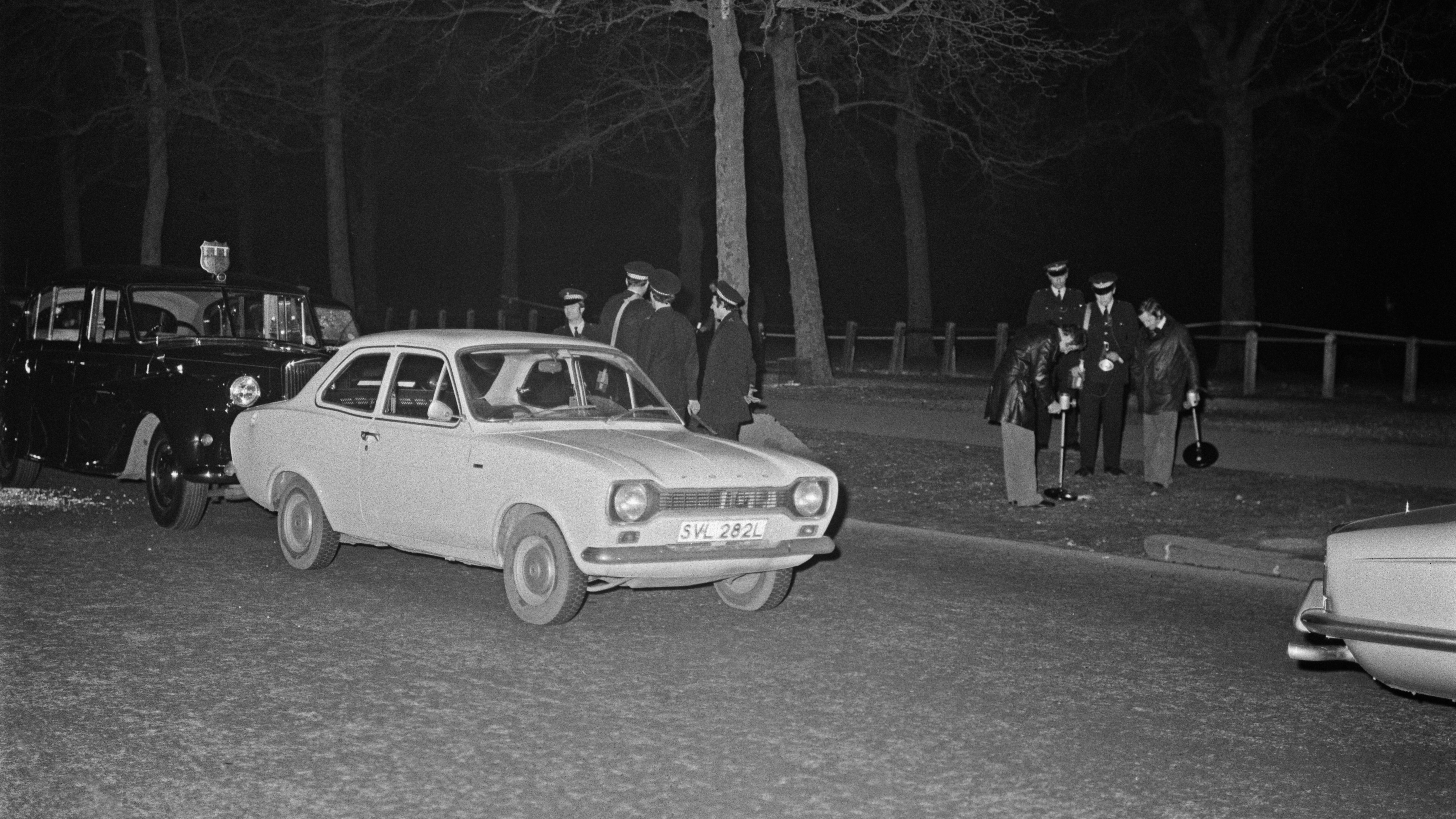 Police searching the Mall for bullets near Buckingham Palace in London, after an attempt was made to kidnap Princess Anne, the Princess Royal, the day before, London, UK, 21st March 1974