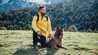 Man in mountains with German shepherd