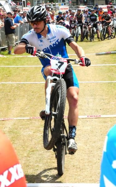 Adam Craig (Giant) does a wheelie up to the starting line