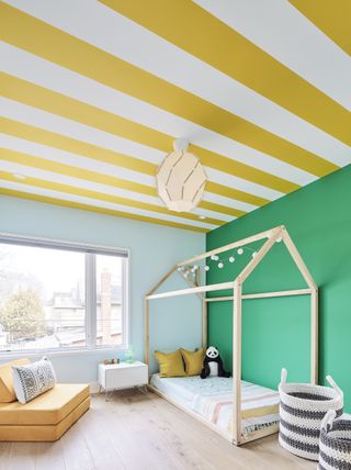 A green bedroom with yellow ceiling