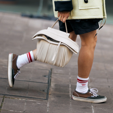 woman wearing brown vans sneakers and shorts in London 