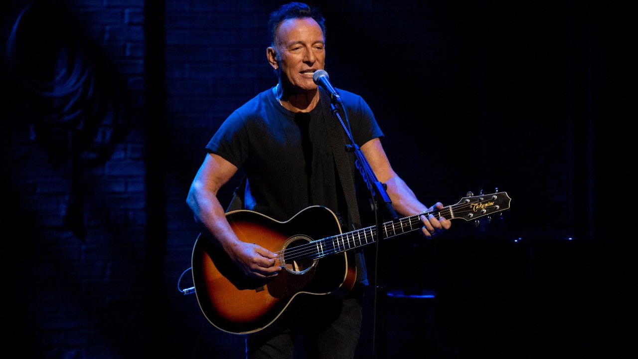 Bruce Springsteen playing a guitar.