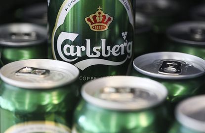 A can of Carlsberg lager beer, produced by Carlsberg A/S, sits on display inside a supermarket in London