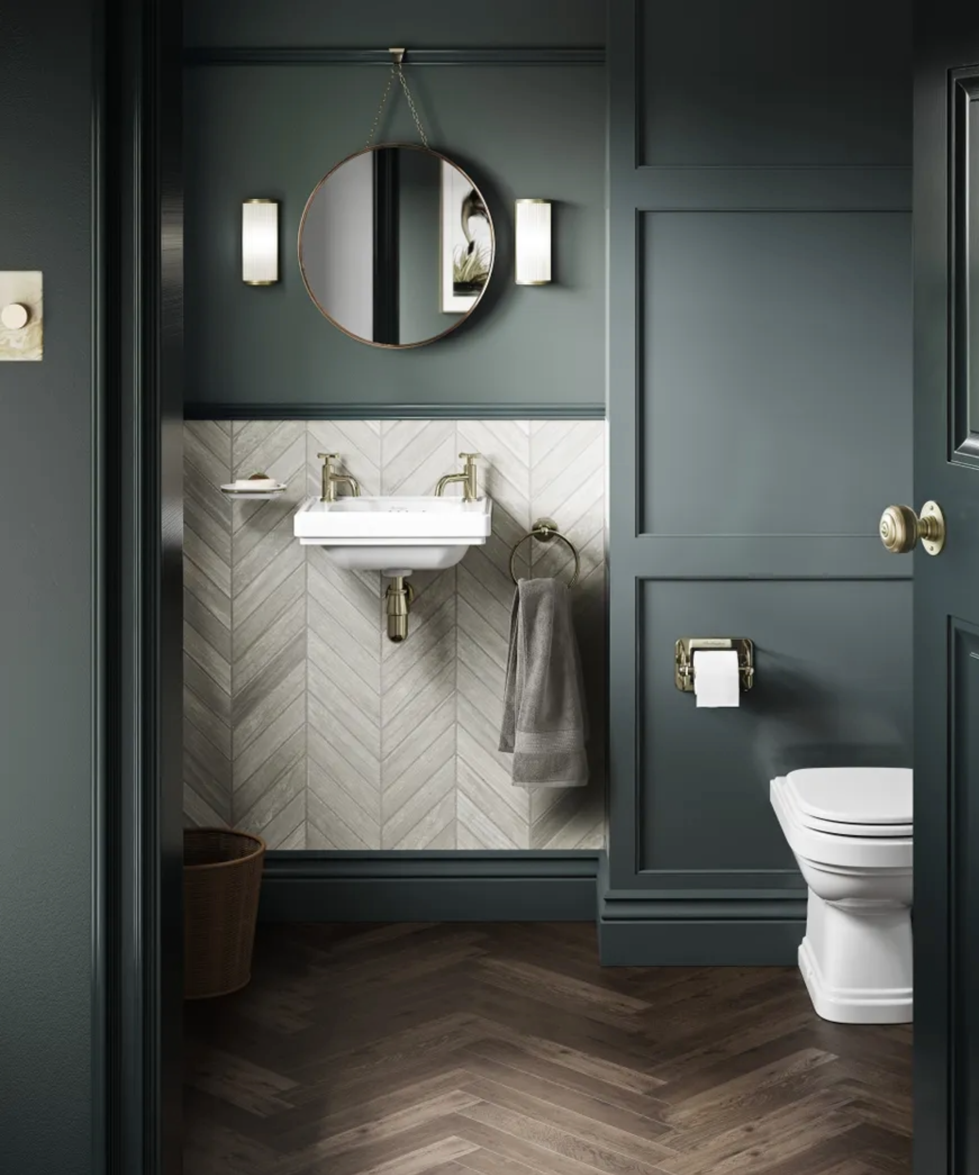 Toilet with green paneling and beige tiles around the basin