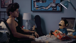 A still from the trailer for the upcoming Prime Video movie Musica in which actor and internet star Rudy Mancuso is sat opposite a puppet.