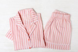 A pair of pink and white pinstriped pyjamas.