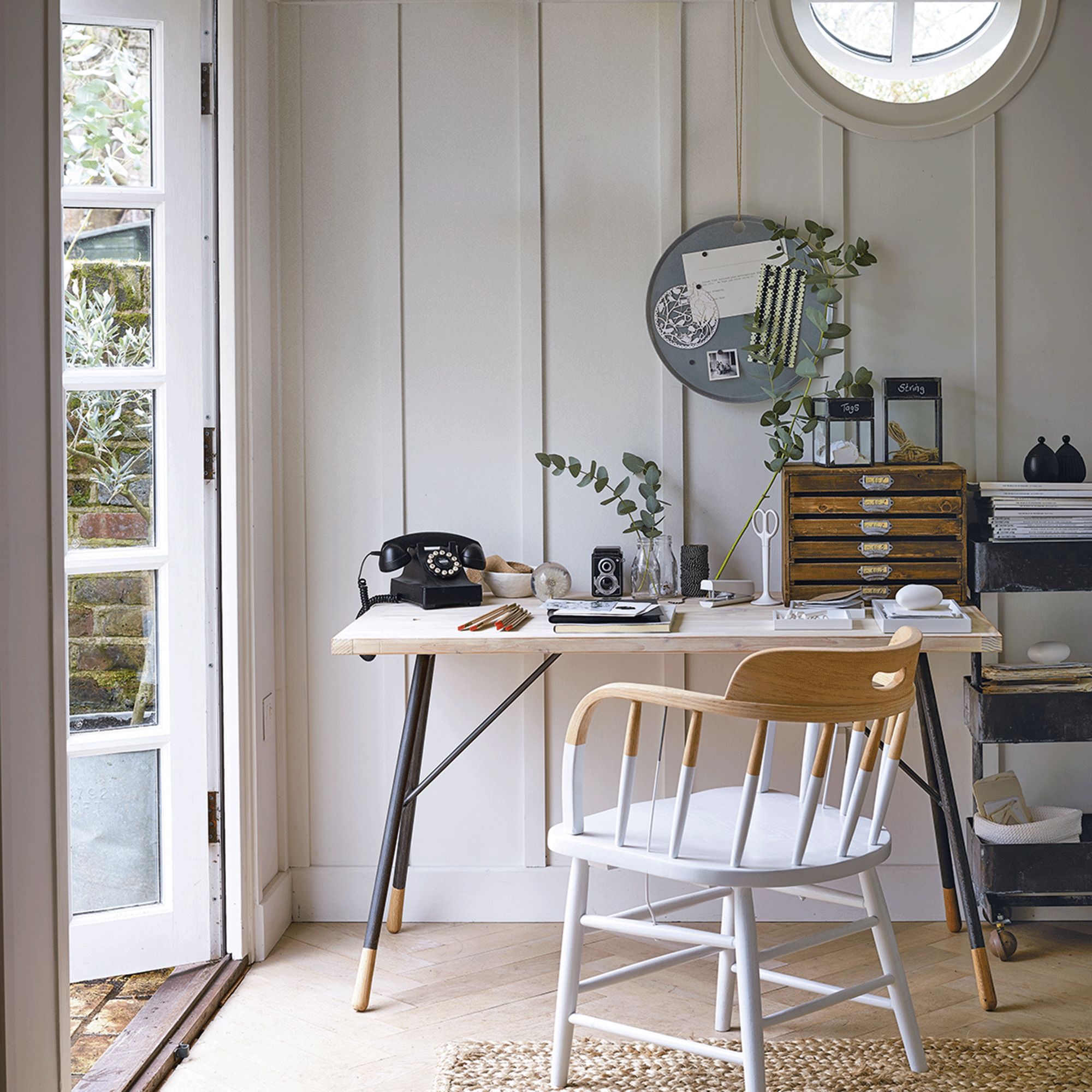 White room with wooden desk and patio door