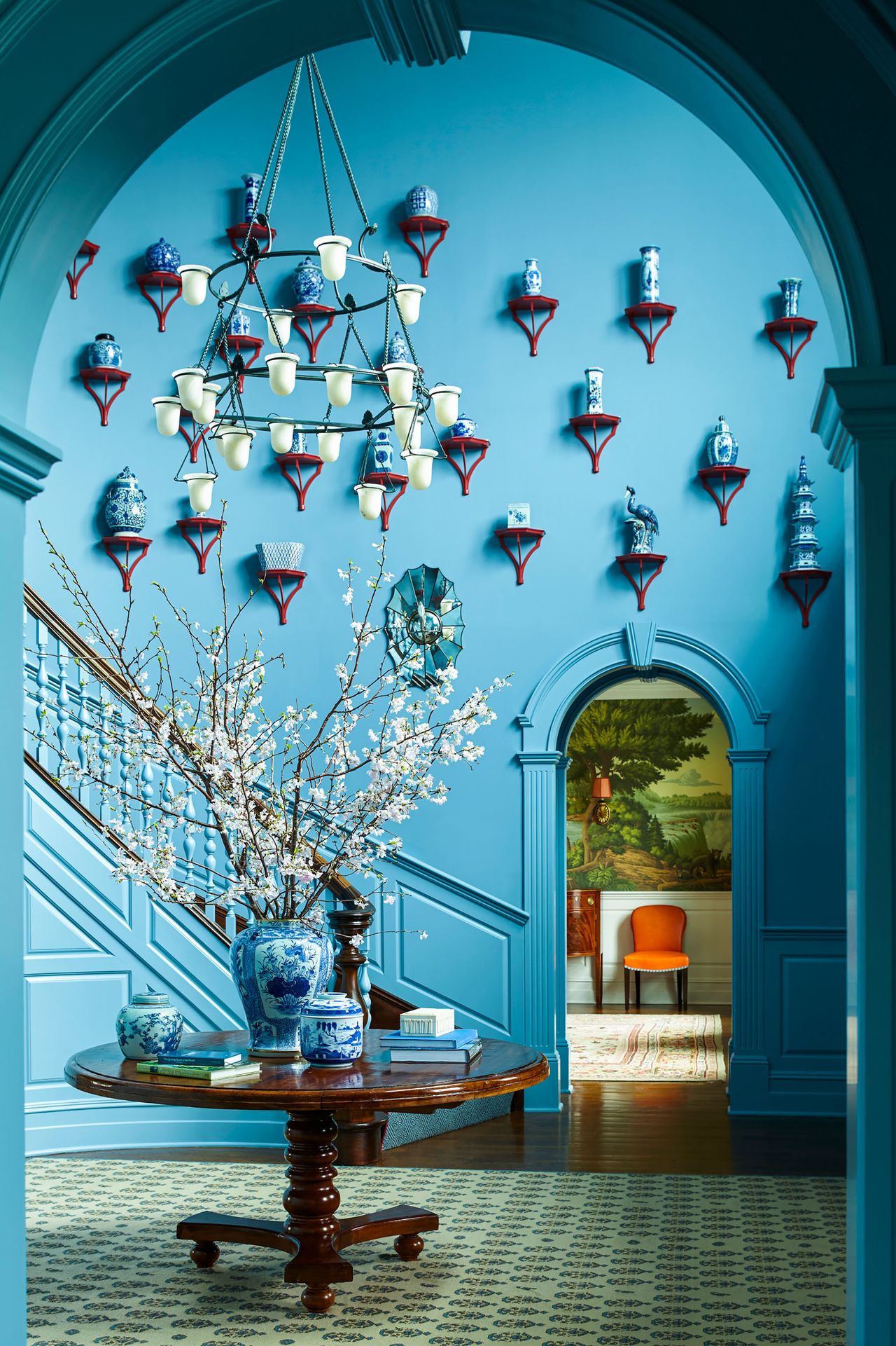 Blue room with red shelves and blue and white china
