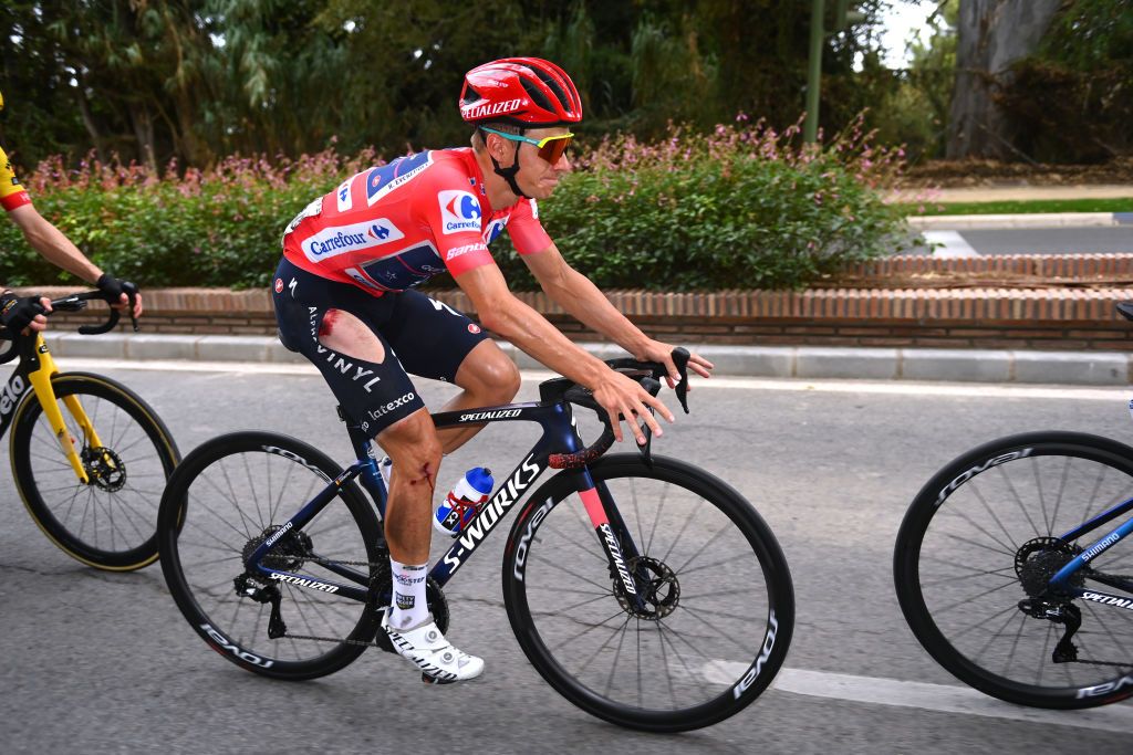 ESTEPONA SPAIN SEPTEMBER 01 Remco Evenepoel of Belgium and Team QuickStep Alpha Vinyl Red Leader Jersey competes injured after being involved in a crash during the 77th Tour of Spain 2022 Stage 12 a 1927km stage from Salobrea Peas Blancas Estepona 1260m LaVuelta22 WorldTour on September 01 2022 in Estepona Spain Photo by Tim de WaeleGetty Images