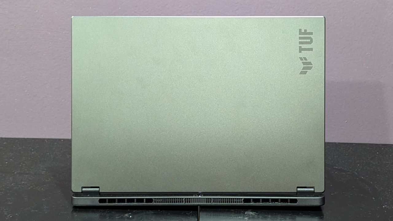 Asus TUF Gaming A14 on a black desk showing the lid.