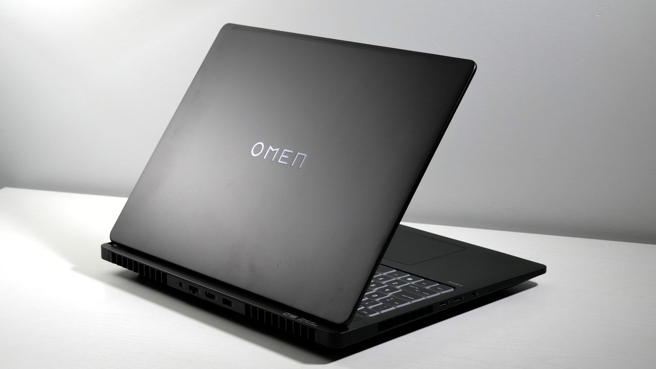 HP Omen Max 16 open on a white desk, angled to the side, highlighting the lid and the keyboard.