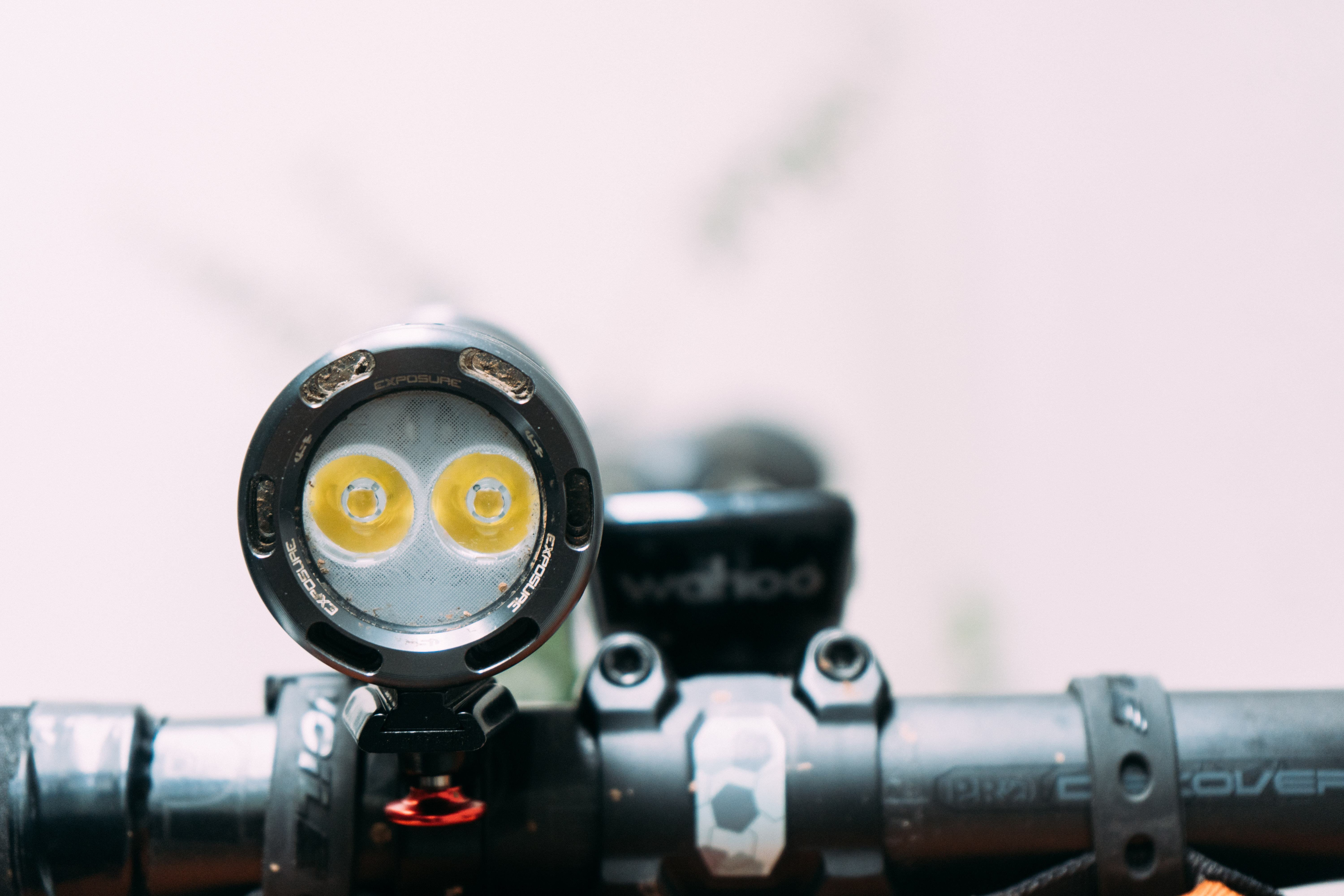 A close up of the twin LED bulbs of a grey bike light