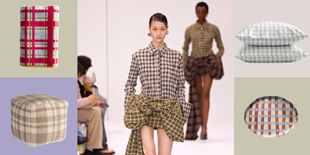 two models walk a runway in plaid outfits surrounded by plaid items