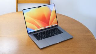 apple macbook pro 16 inch laptop on a wooden table, one of the best photo-editing laptops