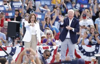 US Vice President and 2024 Democratic presidential candidate Kamala Harris and her running mate Minnesota Governor Tim Walz wave to supporters as they depart after speaking during a campaign rally in Eau Claire, Wisconsin, August 7, 2024.