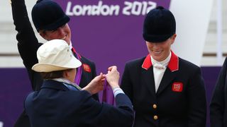 Princess Anne presents Zara Tindall with her Olympic medal