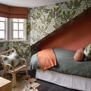 small bedroom with wallpapered sloped walls