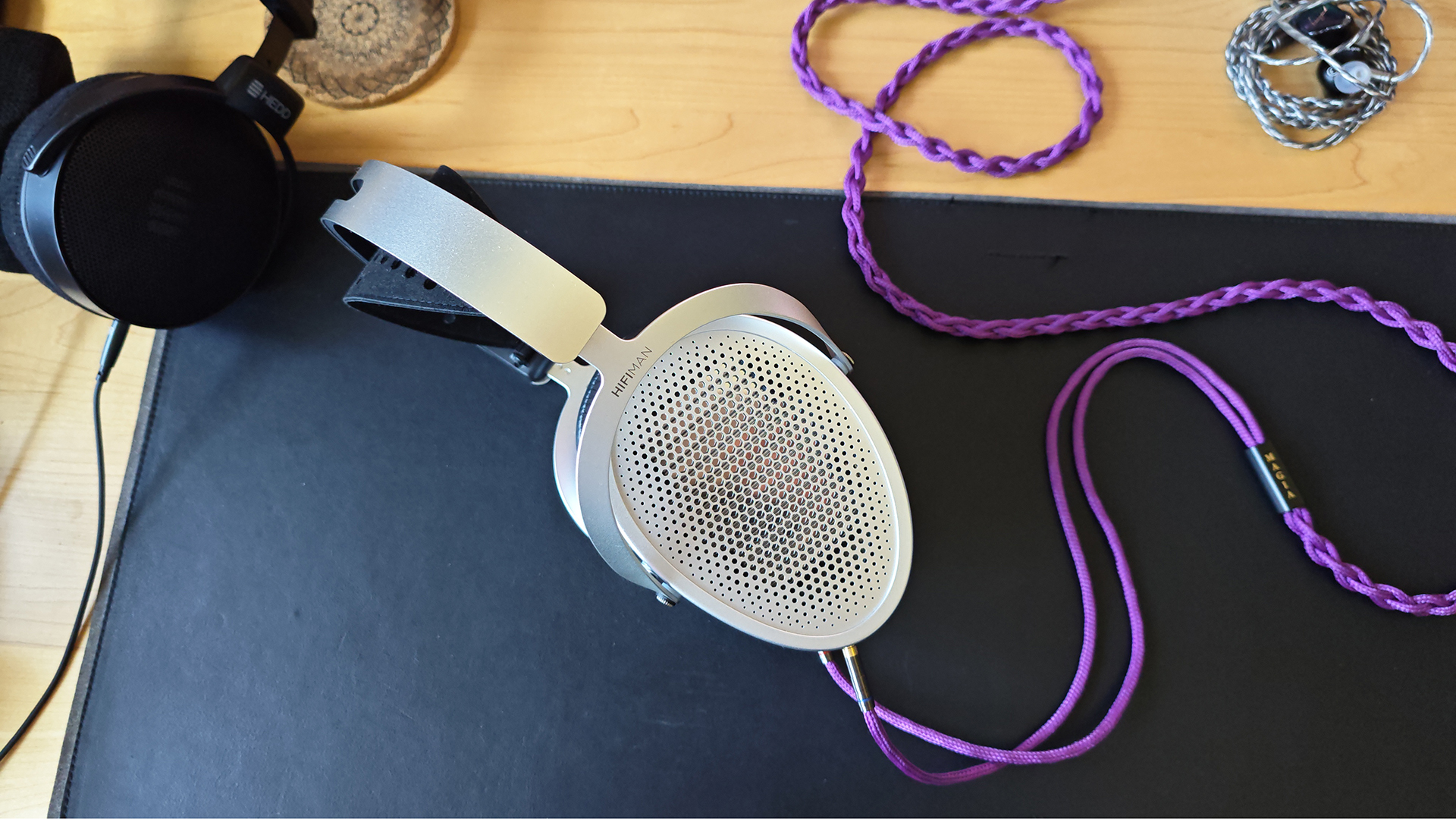 HiFiMan Edition XV headphones on a desktop, with a purple cable.