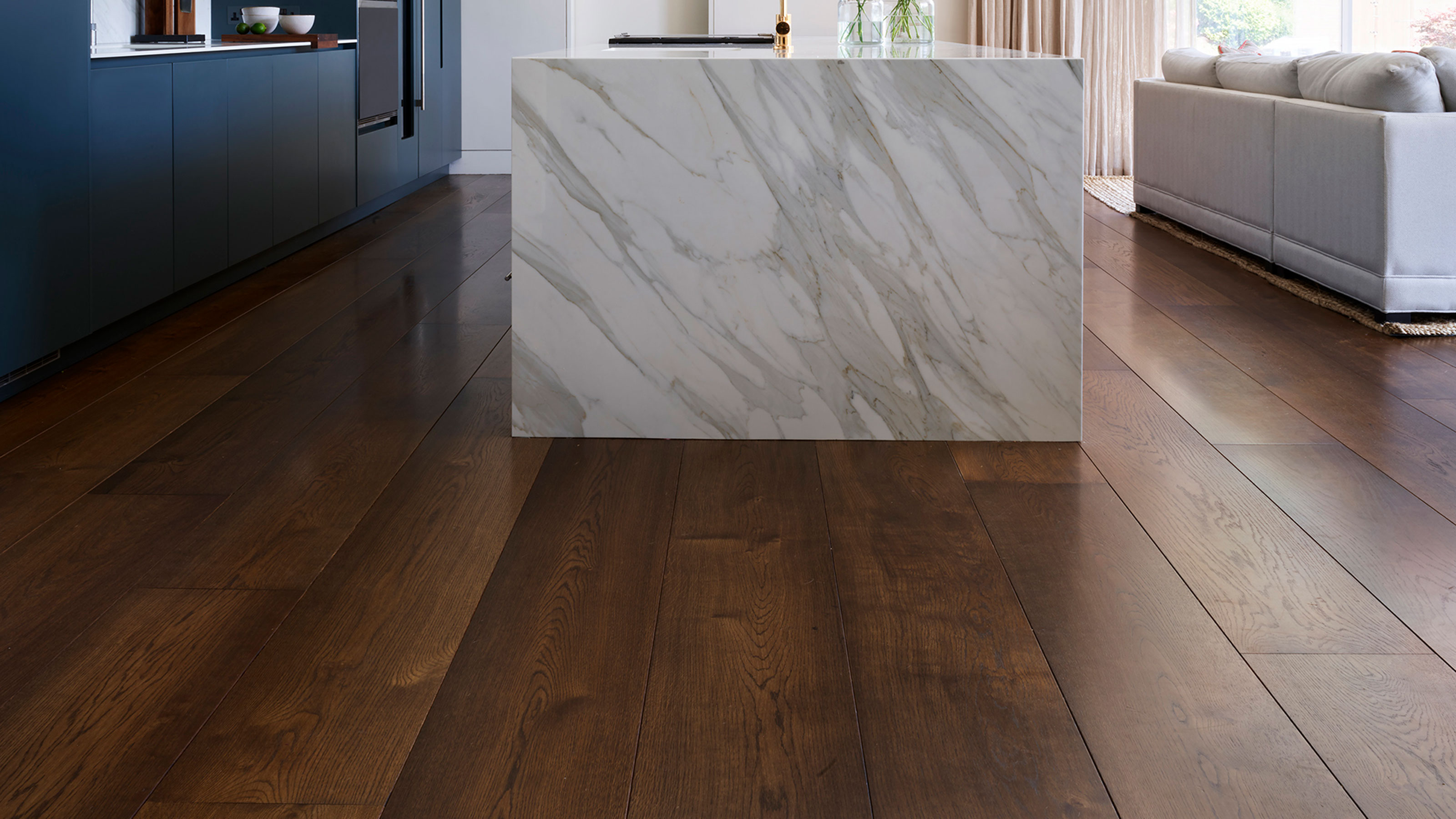 modern luxury kitchen with marble kitchen island and wide plank oak flooring