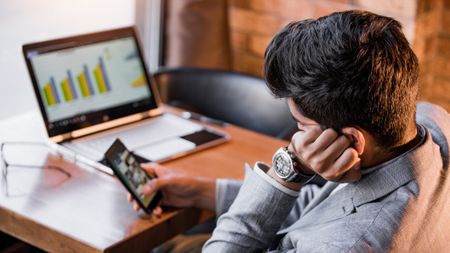 A man looks at his phone when he should be working.