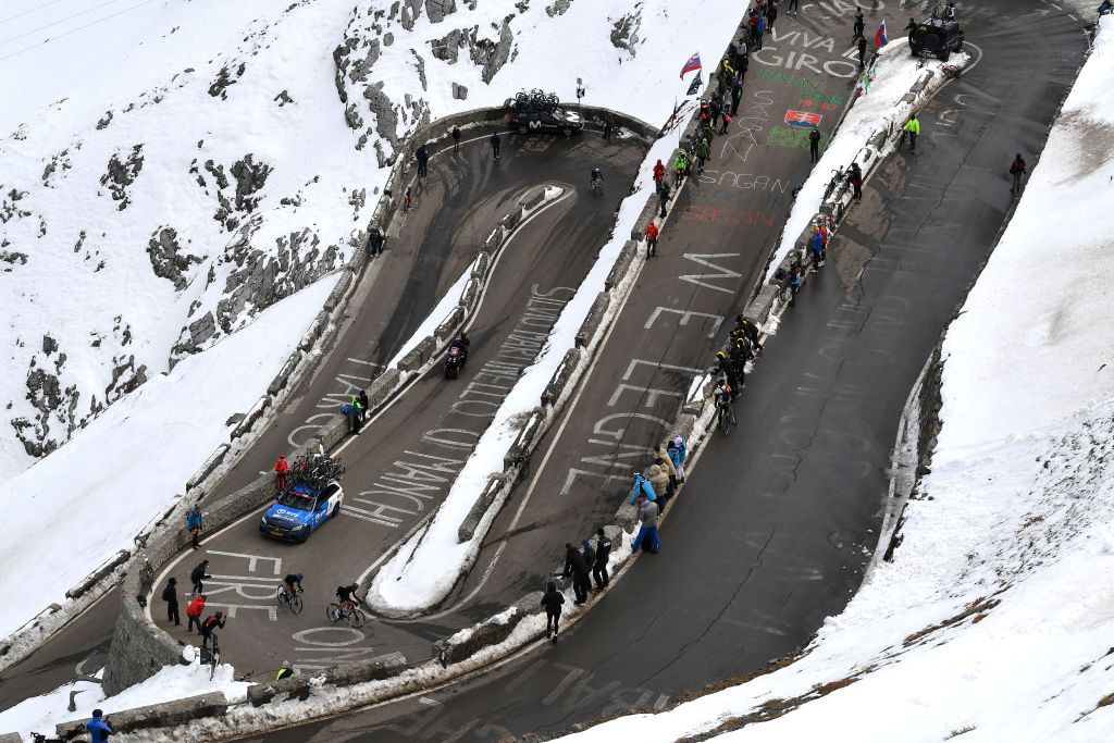 LAGHI DI CANCANO ITALY OCTOBER 22 Ben Oconnor of Australia and NTT Pro Cycling Team Matteo Sobrero of Italy and NTT Pro Cycling Team Passo dello Stelvio Stilfserjoch 2758m Grenadiers Car Team INEOS Grenadiers Snow Fans Public during the 103rd Giro dItalia 2020 Stage 18 a 207km stage from Pinzolo to Laghi di Cancano Parco Nazionale dello Stelvio 1945m girodiitalia Giro on October 22 2020 in Laghi di Cancano Italy Photo by Tim de WaeleGetty Images