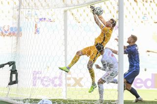 Slovakia goalkeeper Martin Dubravka, top, scores an own goal against Spain