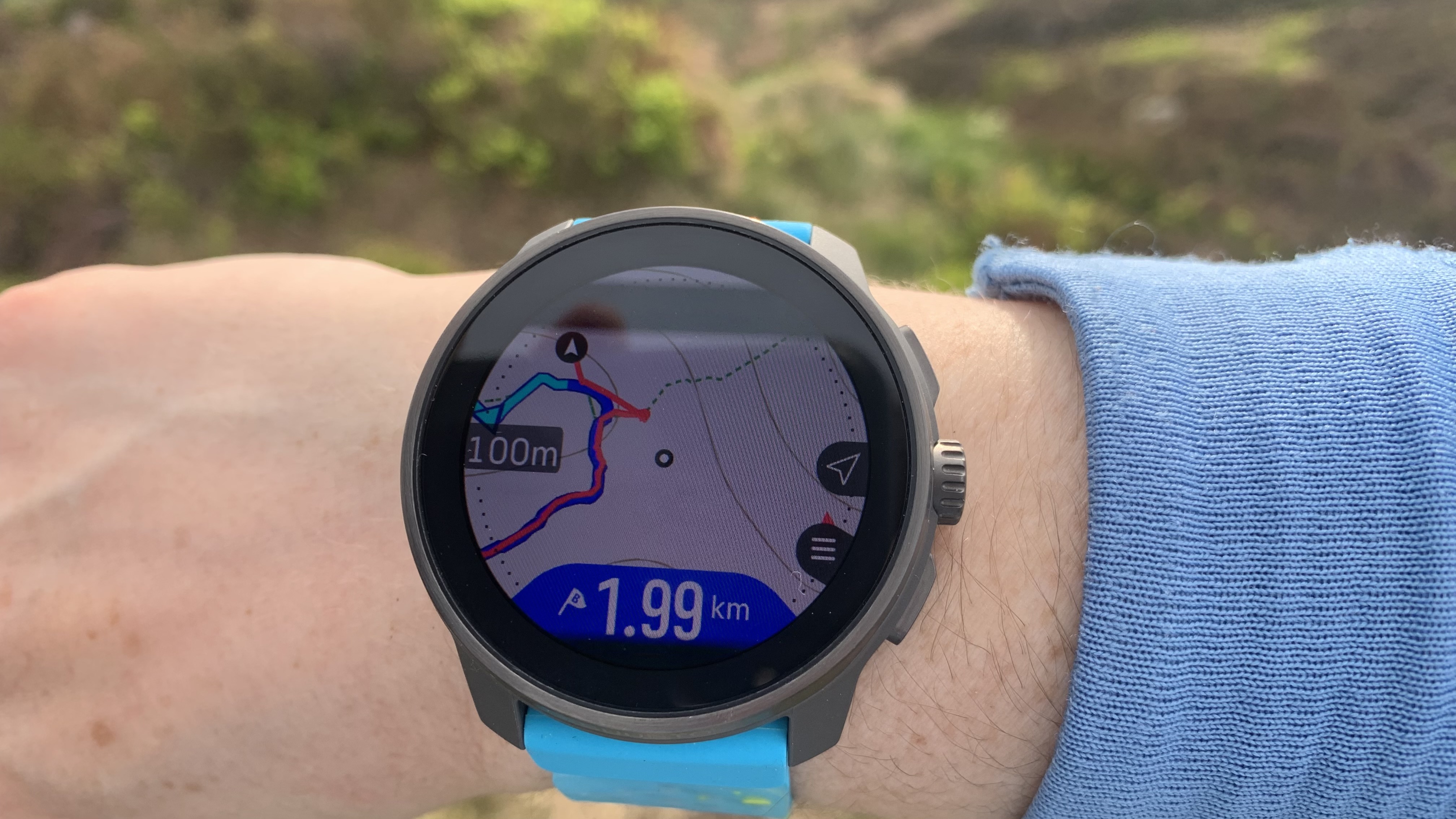 The Suunto Race S watch on wrist showing map