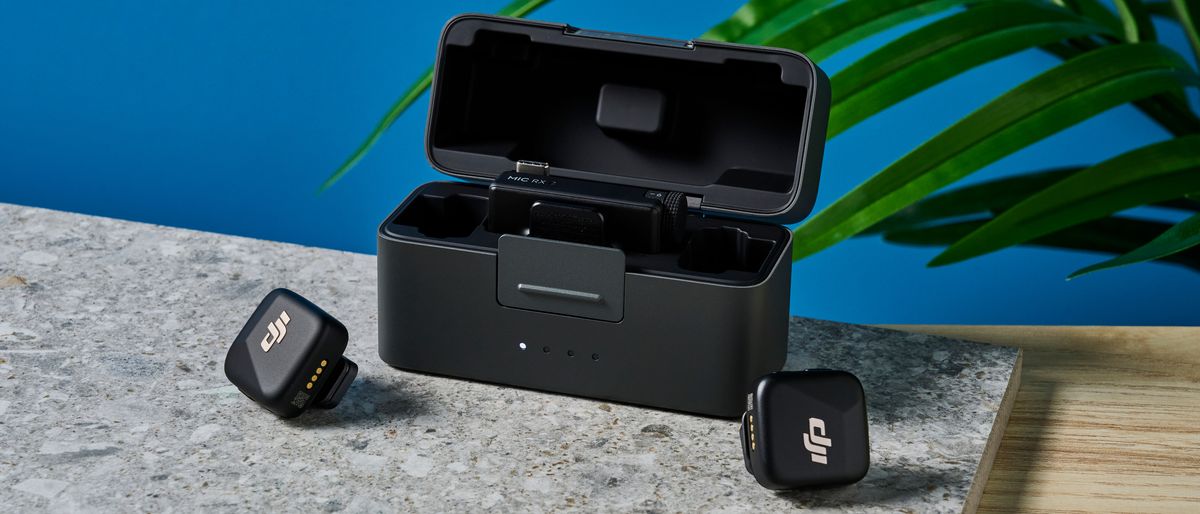 The DJI Mic Mini in black on a stone surface.