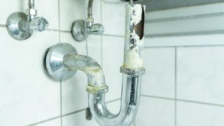 Corroded drainpipe in bathroom