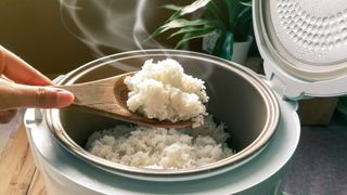 Spooning rice from a rice cooker