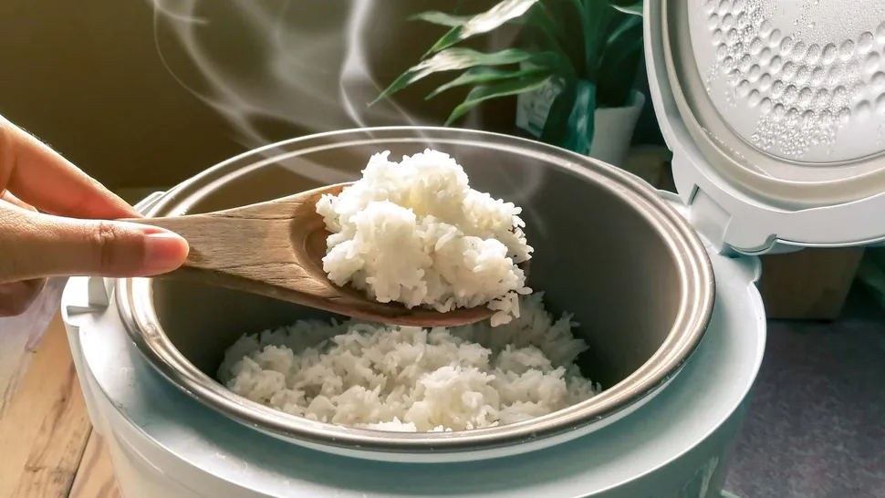 steaming hot rice being served from an electric rice cooker, perfect for a wholesome meal