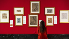 A visitor sitting looking at works at the Drawing the Italian Renaissance exhibition at The King's Gallery.