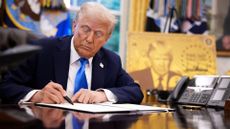 President Donald Trump signs an executive order in the Oval Office at the White House on September 19, which introduced a new $100,000 fee for H-1B visa applications. 