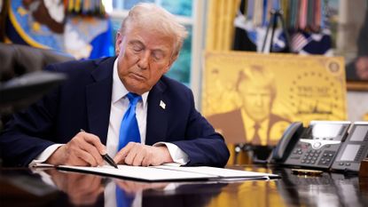 President Donald Trump signs an executive order in the Oval Office at the White House on September 19, which introduced a new $100,000 fee for H-1B visa applications.