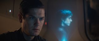 Kyle Soller as Syril Karn stares at a holographic image of Cassian Andor in Andor