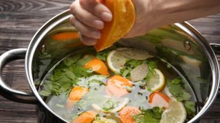 A pot with saltwater, oranges and herbs to brine a turkey