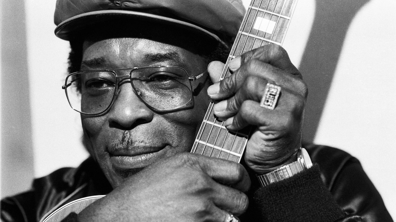 A close-up of Buddy Guy holding his guitar