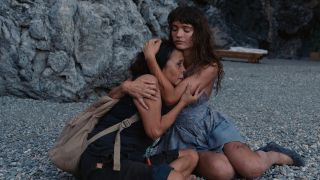 Charlbi Dean Kriek and Dolly De Leon hug in Triangle Of Sadness