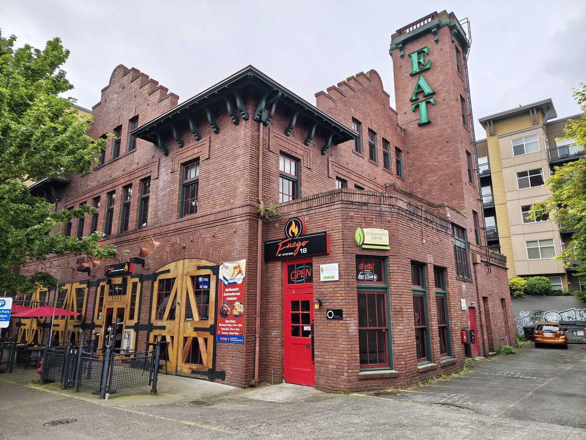 A large brick building with a red door