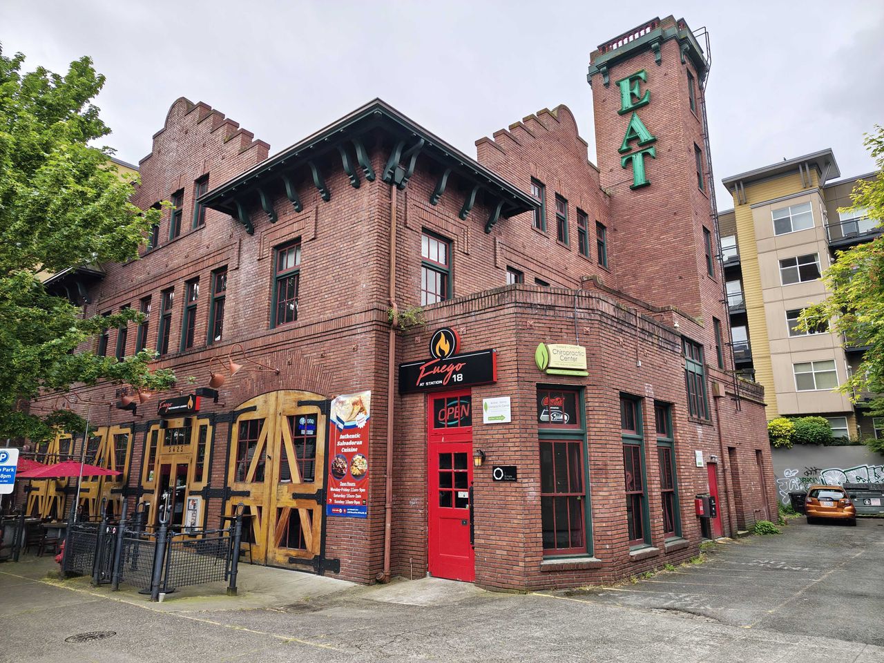 A large brick building with a red door