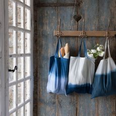 blue wooden wall with hanger blue cloth bags on hanger