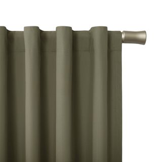 close up of olive green curtains on stainless silver curtain rod