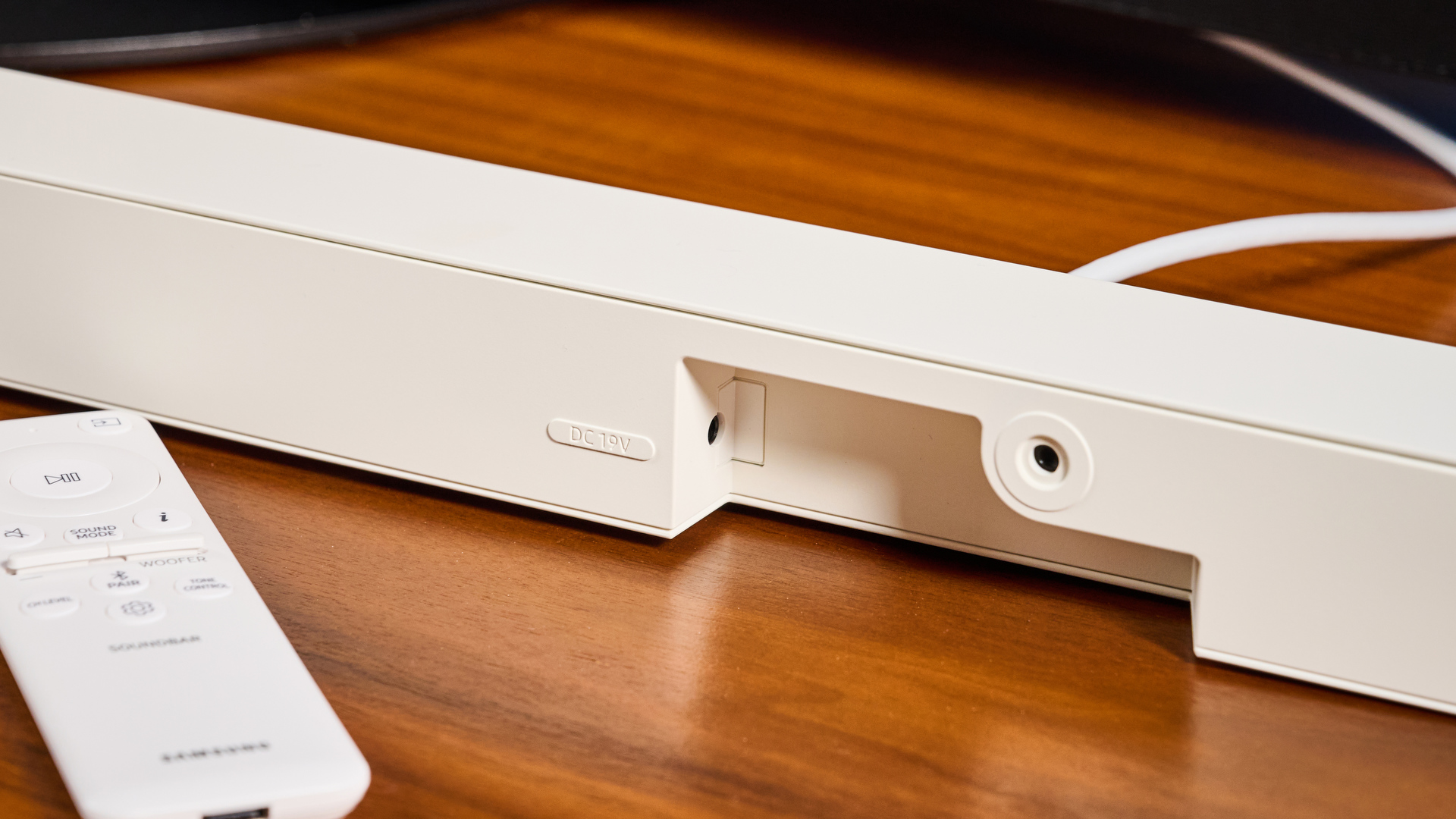 the samsung hw-s801d soundbar and subwoofer in white, an ultra slim soundbar with on-bar buttons, a remote, and separate subwoofer with a black cone